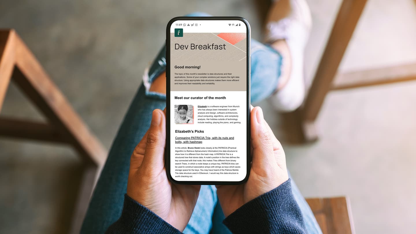 Hands holding smartphone displaying "Dev Breakfast" newsletter about data structures with curator Elizabeth's profile and picks.